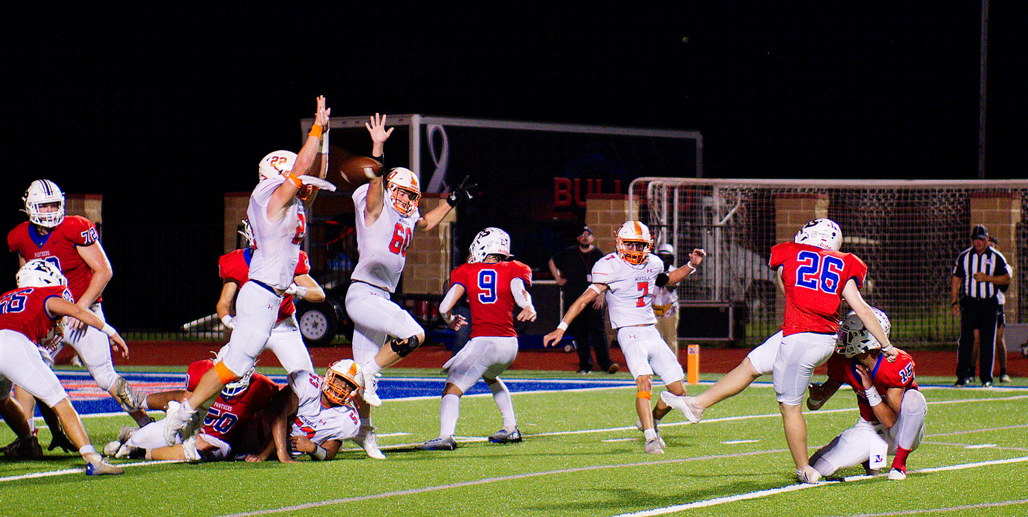 Dawson Pendergrass blocks the Bullard extra point kick to preserve the 36-36 tie. Mineola went on to win the game in overtime on a Pendergrass two-point conversion. [find more football photos]
